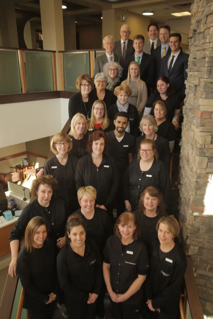 Picture of the staff and the Dr's all standing on the interior stairs 