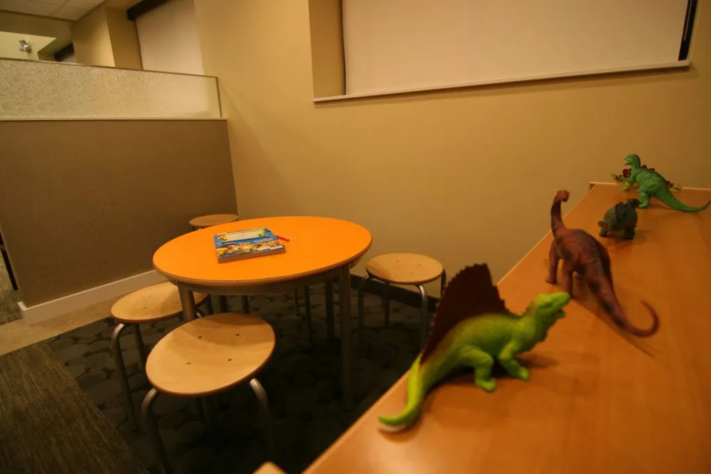 Waiting room & children's area with dinosaurs toys on shelf 